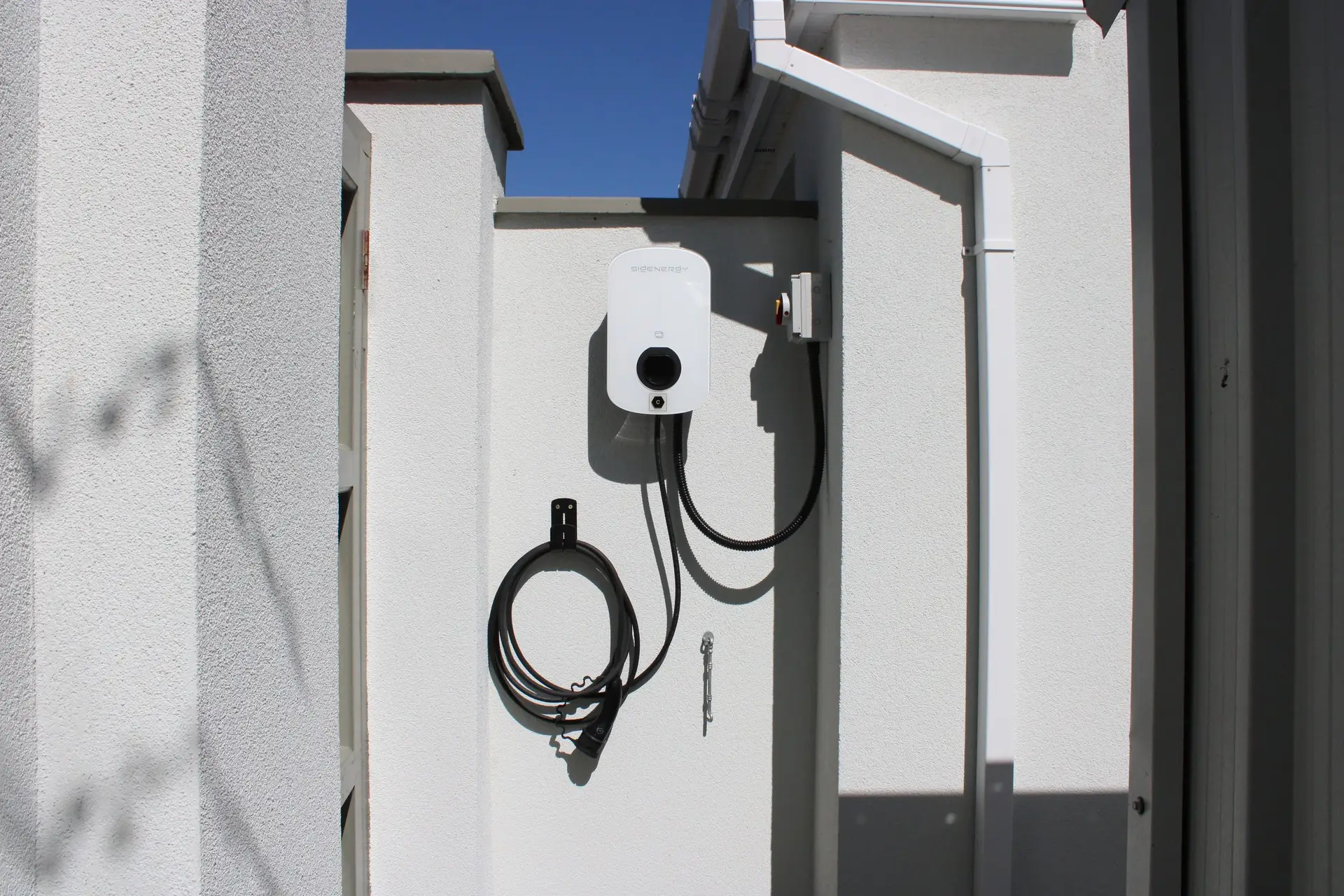EV charge point mounted on an exterior house wall