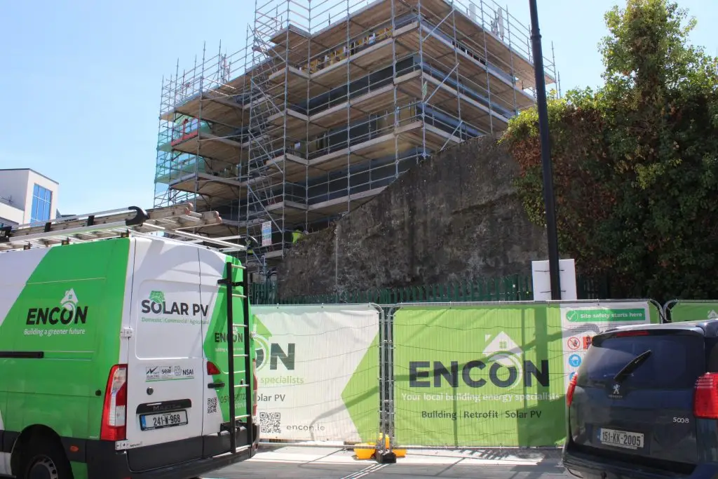 ENCON van at a scaffolded apartment building