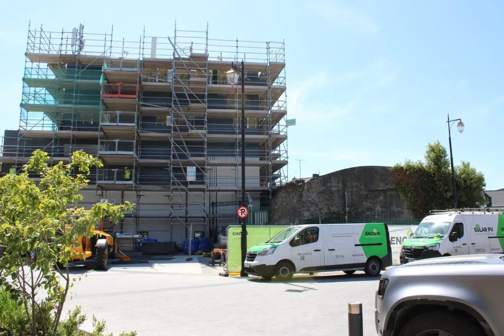 Scaffolded apartment block with ENCON vans on site