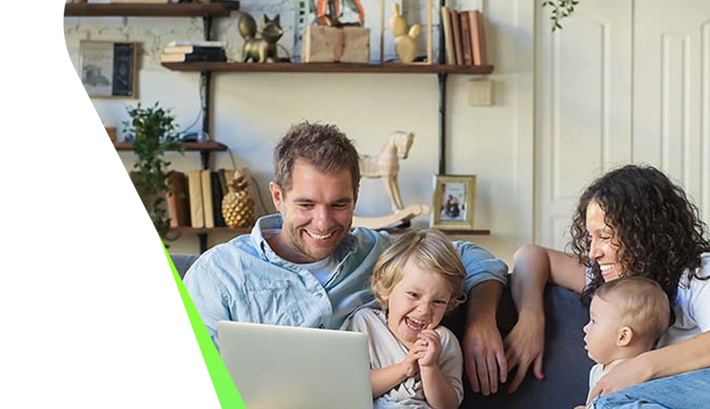 Family together on a sofa at home with a laptop