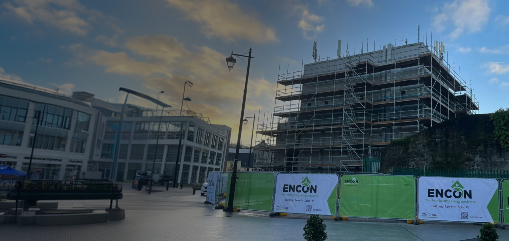 Scaffolded building under construction with ENCON site hoarding