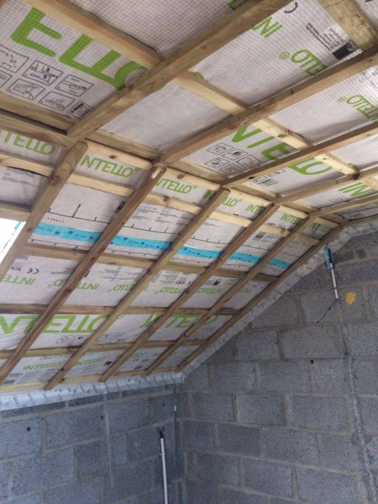 Attic interior showing roof timbers and a blockwork gable