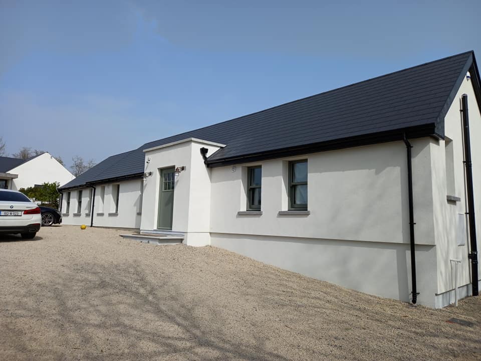 White rendered house with a dark tiled roof
