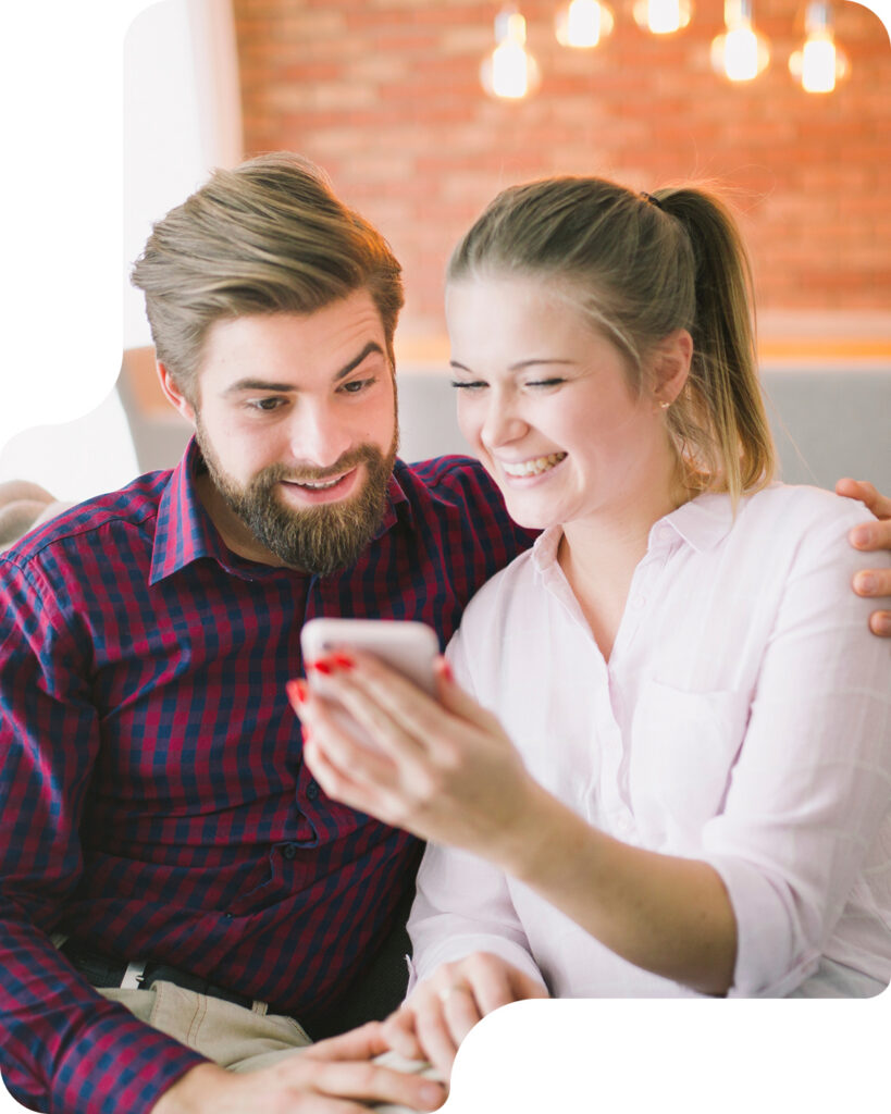 Couple looking at a phone together at home
